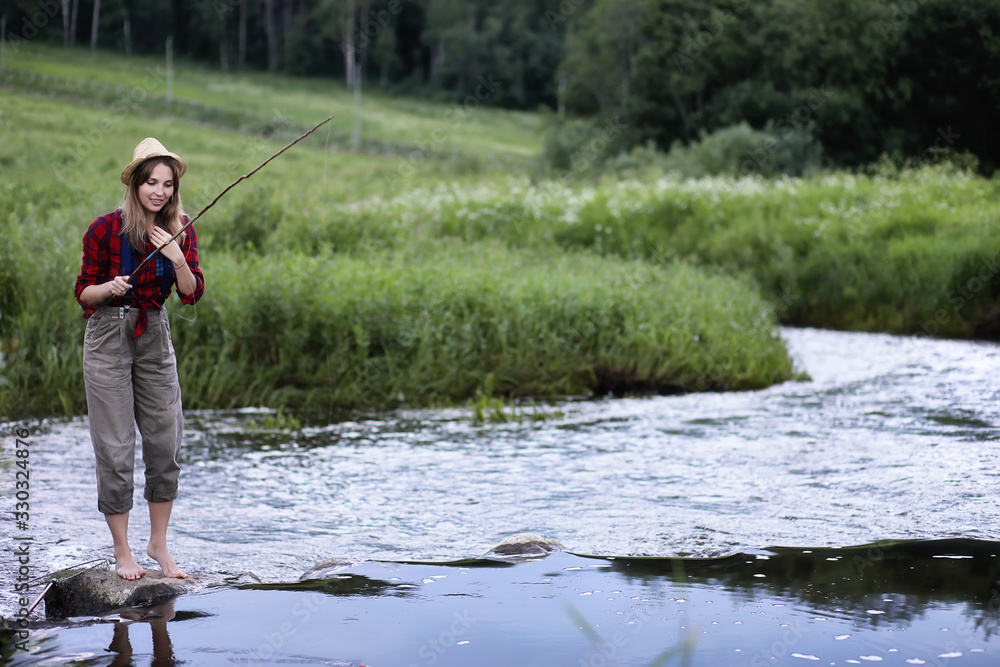Girl by the river with a fishing rod Girl by the river with a fishing rod
