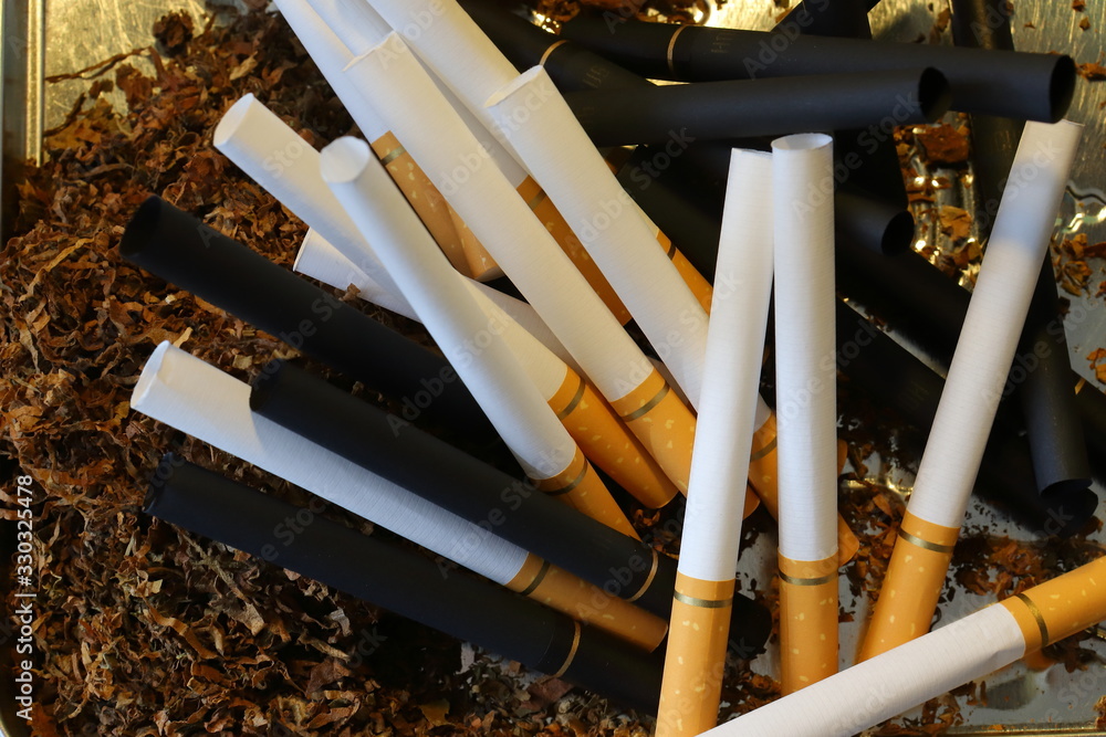 cigarette filters Empty cigarette paper Several white and black