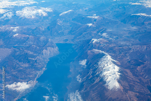 mountain peak covered by snow , aerial view of mountains and lake 