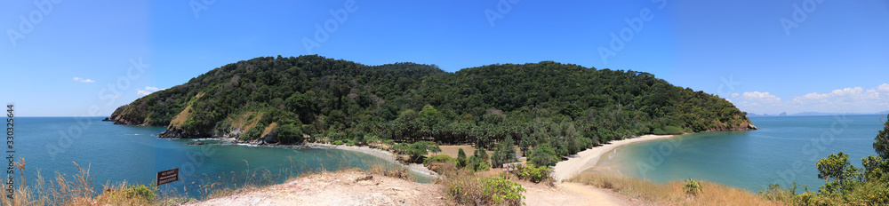  A part of the panoramic view of the Ko Lanta National Park, Krabi, Thailand, which has a palm tree garden, a wide courtyard and a beach and a beautiful rock beach.
