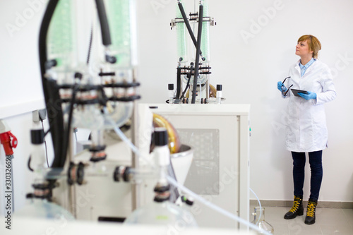 Scientist operating on rotavapor machine in during CBDa oil extraction