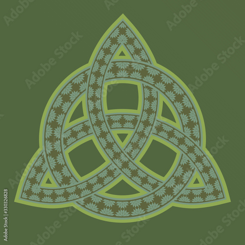 Ornamented celtic pagan symbol triquetra on green background