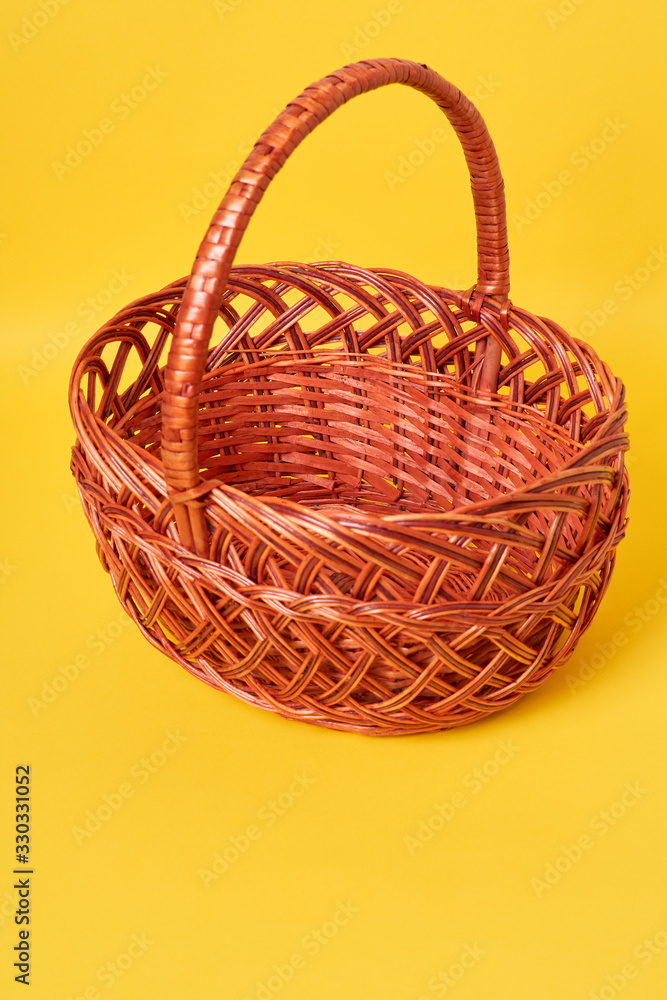 Brown basket in yellow background
