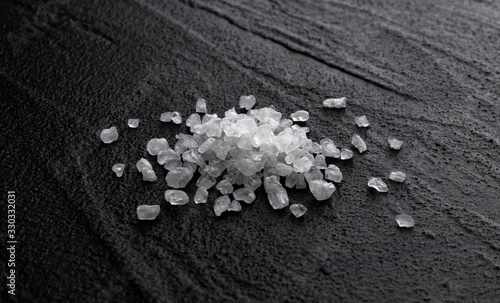 Pile of sea salt on black background photo