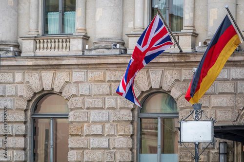 Flag of Great Britain and Flag of Germany waving outdoors in Berlin, Germany, Europe photo