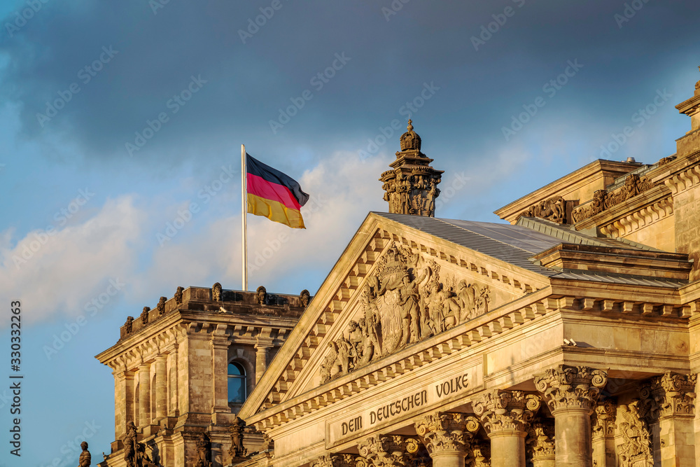 German flag waving outdoor above governmental building of Reichstag, Berlin, Germany