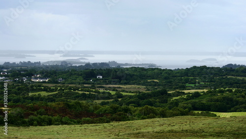 beautiful green summer landscape from Connemara, Galway, Ireland overlooking Lough Corrib and the local forests and villages