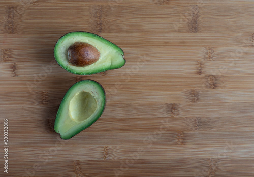  Sliced avocado on wooden table, high resolution photo