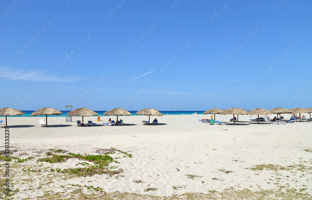 Tourists are resting on the beach. Wide sandy beach Tourists are resting on the beach. Wide sandy beach