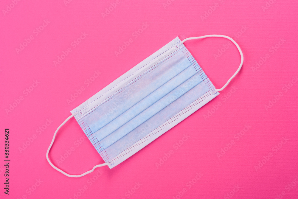 Medical mask on a colored background, a means of protection against coronovirus and epidemic Medical mask on a colored background, a means of protection against coronovirus and epidemic