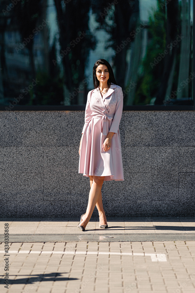 Fototapeta premium Attractive brunette in dress outdoors in spring