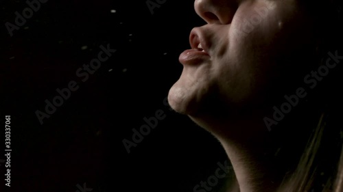 Female Profile Sneezing Slow Motion. a profile view of a woman sneezing in slow motion spraying germs