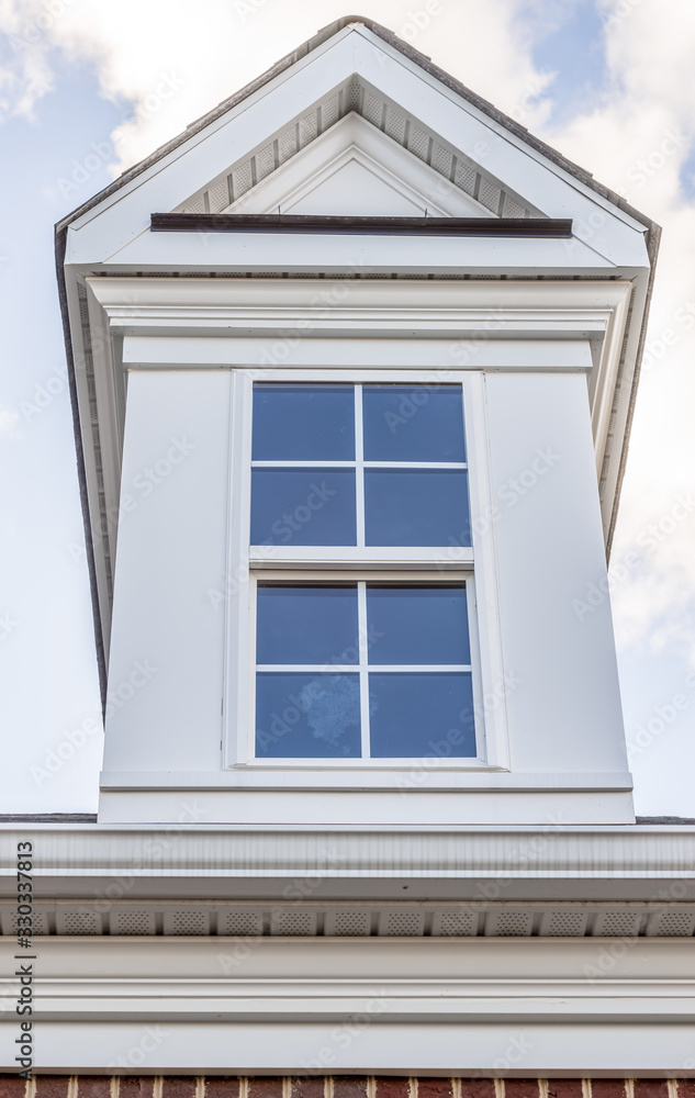 Classic single dormer window with decorative triangle trim, double hung