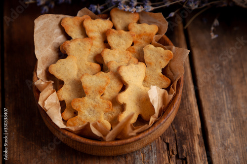 Homemade cookies in the shape of bears. Baking on the kitchen table. Flour product. Still life, close-up. Teddy bear cookies.