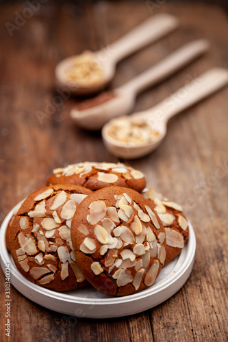 Almond Chip Cookies. Almonds on a round homemade cookie. Still life  food closeup on a wooden table. Appetizing pastries.