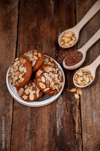 Almond Chip Cookies. Almonds on a round homemade cookie. Still life, food closeup on a wooden table. Appetizing pastries.