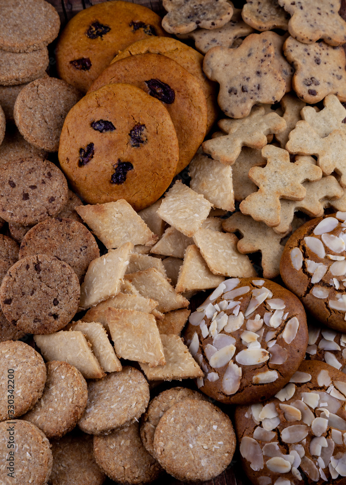 A set of different homemade cookies. Cookies close-up. Background from delicious pastries. Cookie with coconut, mishdal, chocolates, raisins, lingonberries. Round, rhombuses, bears, flowers shapes. A set of different homemade cookies. Cookies close-up. Background from delicious pastries. Cookie with coconut, mishdal, chocolates, raisins, lingonberries. Round, rhombuses, bears, flowers shapes.
