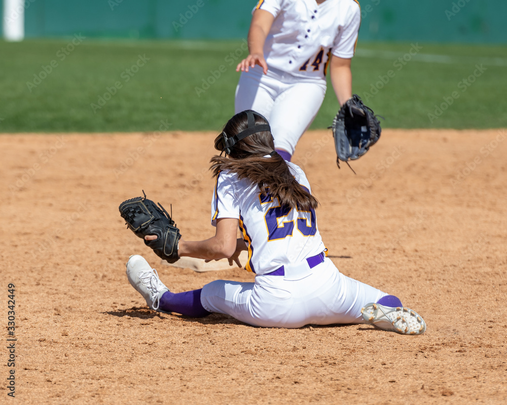 Girl Fastpitch Softball player in action during a competitive game Girl Fastpitch Softball player in action during a competitive game