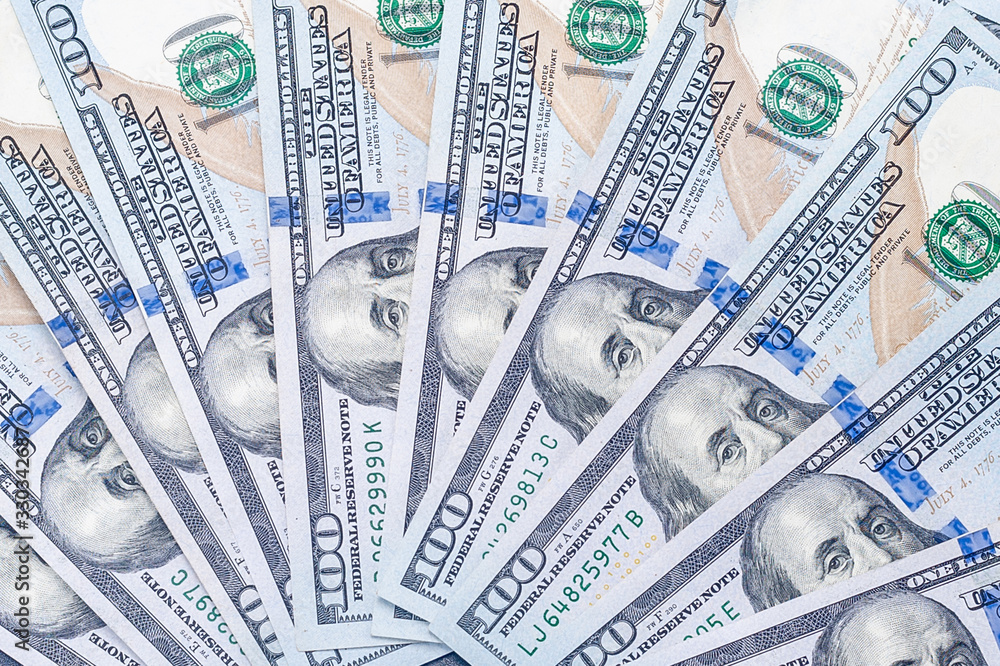 enlarged fragment of many new hundred-dollar US bills with a portrait of President Benjamin Franklin enlarged fragment of many new hundred-dollar US bills with a portrait of President Benjamin Franklin