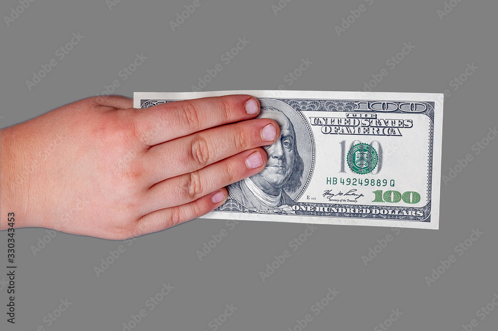 Φωτογραφία Man's hand holds a banknote of 100 US dollars with a portrait of American Presid
