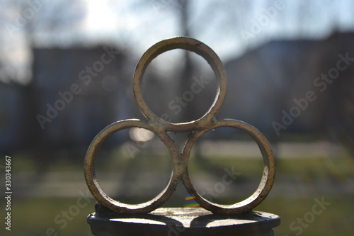 Golden rings in the sunlight at the entrance to the park
