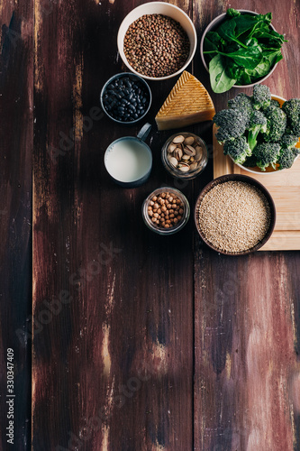 Vegetarian and vegan protein  Natural products on wooden table. Chickpeas  beans  broccoli  quinoa  spinach  pistachios  etc. Animal protein substitute