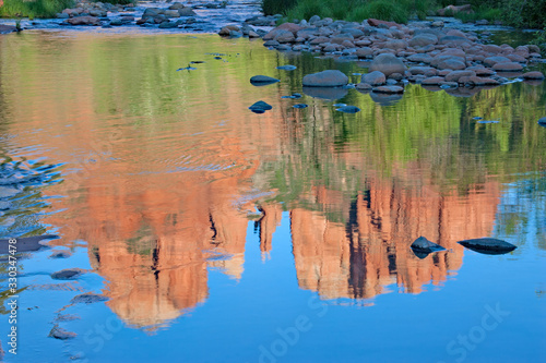 Brilliant reflections of Cathedral Rock on Oak Creek near Sedona  Arizona on cloudless summer afternoon.