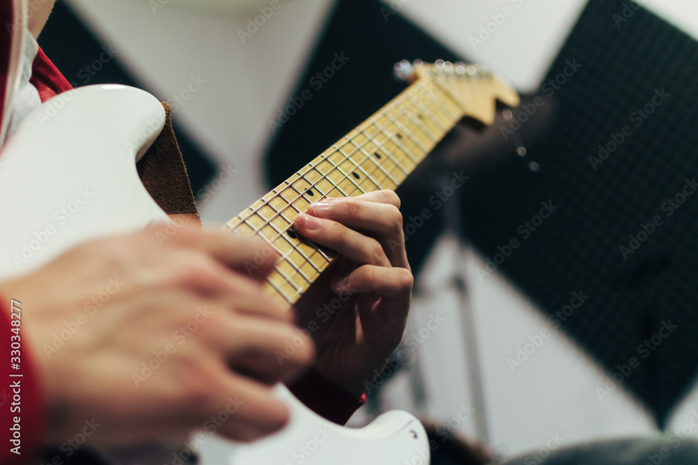 Fototapeta premium Guitar player with white guitar playing a solo