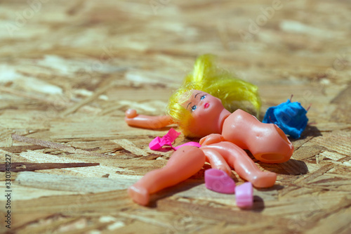 Doll body parts on a wooden background. Copy space. Top view