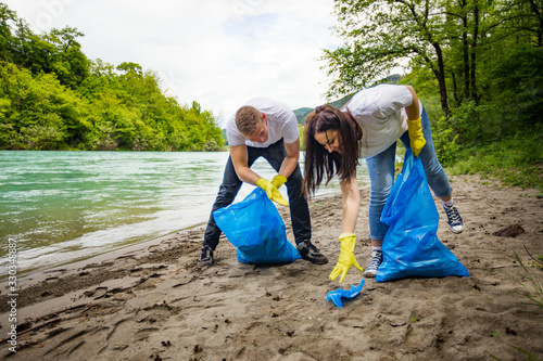 Volunteers collecting garbage at river shore