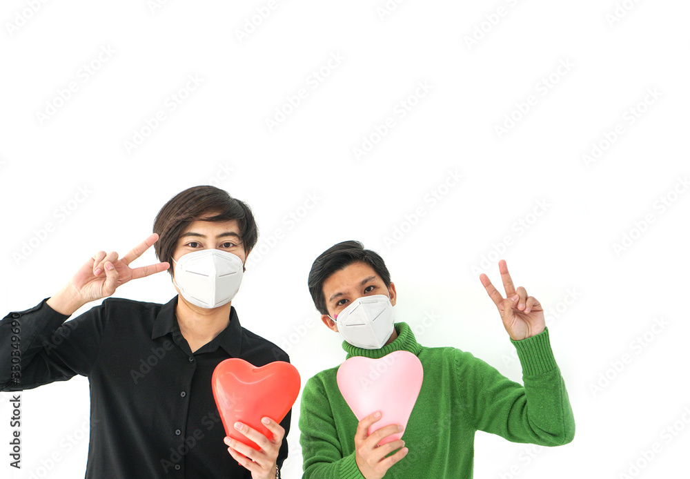 Two Asians friends wearing mask victory gesture positive enourage with Covid-19 virus better situation