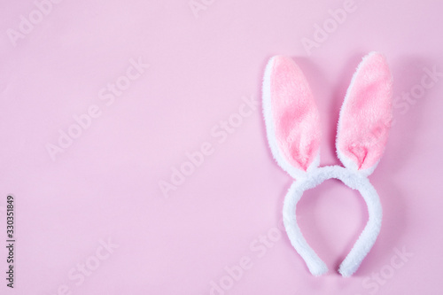 pink bunny ears over wooden table