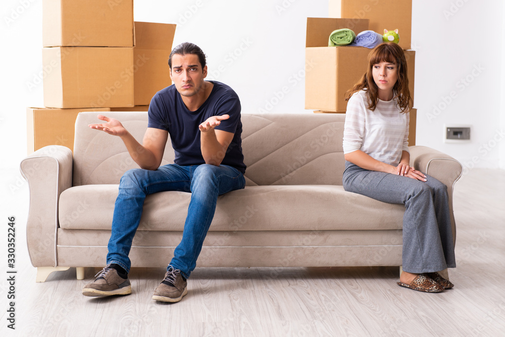 Young pair and many boxes in divorce settlement concept Young pair and many boxes in divorce settlement concept