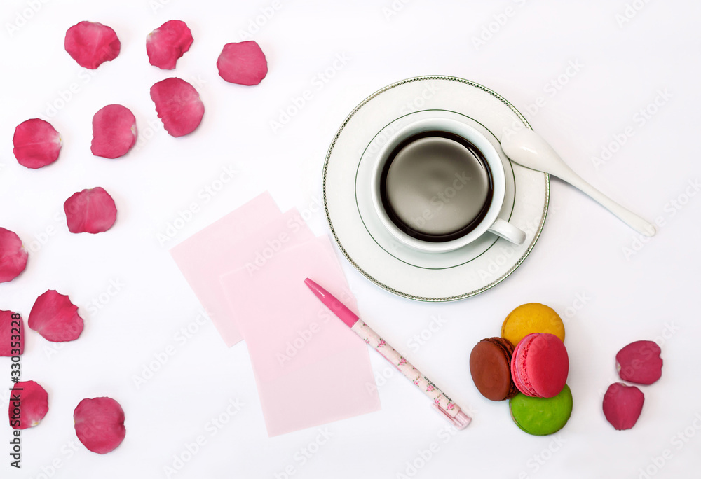 cup with coffee and macrons, pen and note paper. cup with coffee and macrons, pen and note paper.