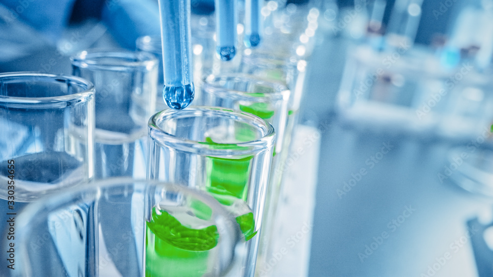 Pharmaceutics Laboratory: Multiple Pipettes Dropping Blue Liquid into Test Tubes, Medical Research and Analysis. Product Line; Dropper Fills Sample Tubes for DNA Study. Close-up Macro Pharmaceutics Laboratory: Multiple Pipettes Dropping Blue Liquid into Test Tubes, Medical Research and Analysis. Product Line; Dropper Fills Sample Tubes for DNA Study. Close-up Macro