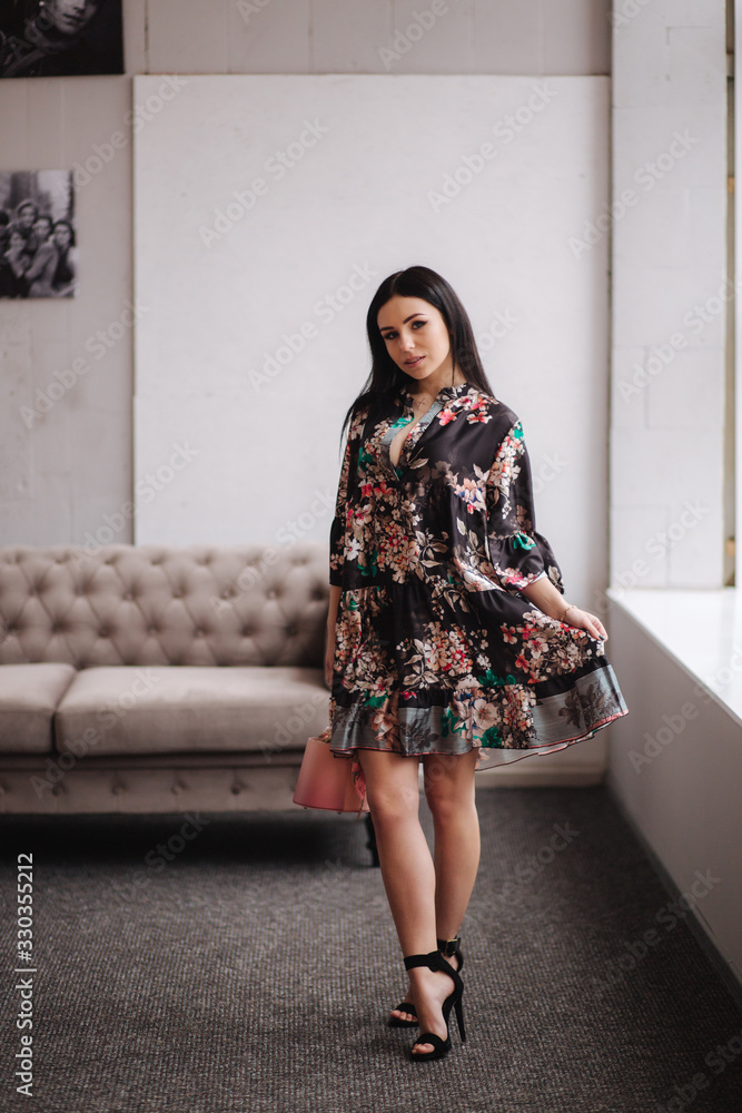 Attractive young model demonstrating clothes. Spring colections on elegant brunette woman Attractive young model demonstrating clothes. Spring colections on elegant brunette woman