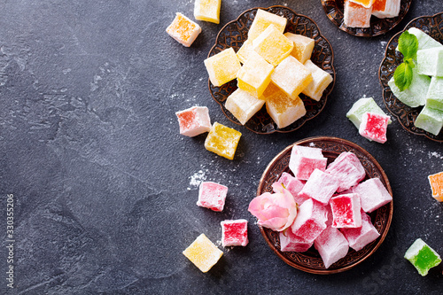Assortment of Turkish delights. Dark background. Copy space. Top view.