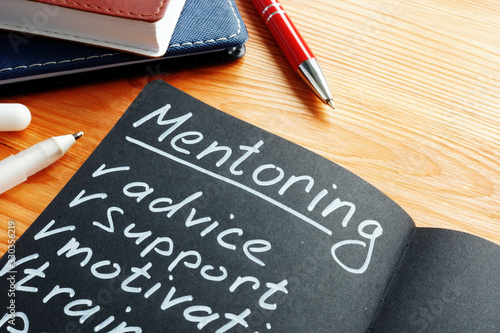 Valokuva Mentoring with mentor list advice, support and motivation in the notepad