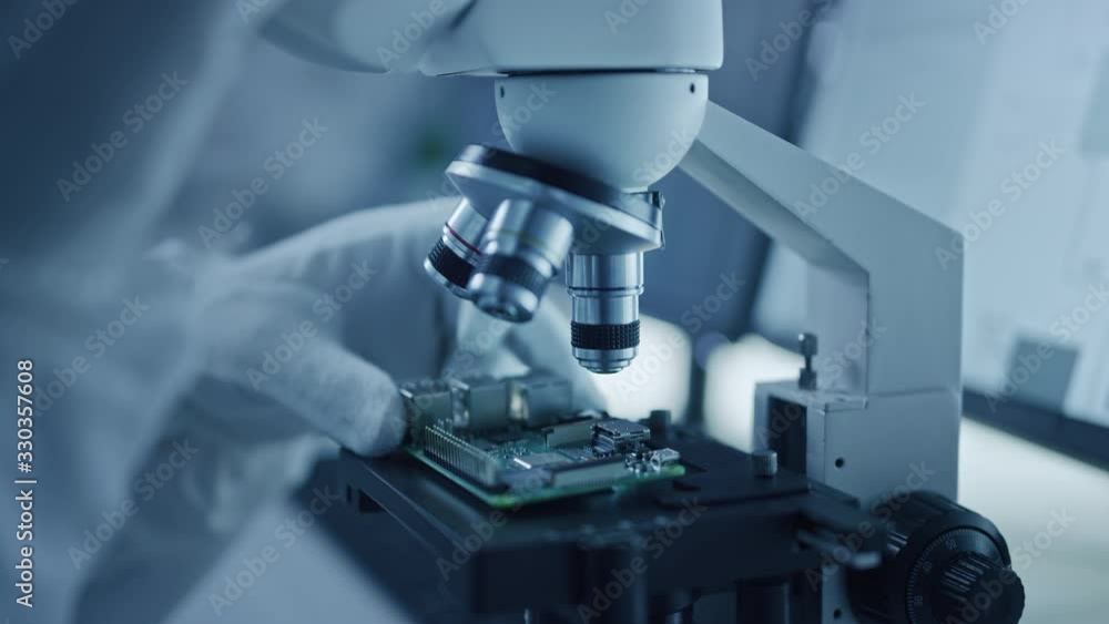 Research Factory Cleanroom: Close-up of Engineer / Scientist wearing Coverall and Gloves Use Microscope to Inspect Motherboard Microprocessor Component, Developing High Tech Modern Electronics Research Factory Cleanroom: Close-up of Engineer / Scientist wearing Coverall and Gloves Use Microscope to Inspect Motherboard Microprocessor Component, Developing High Tech Modern Electronics