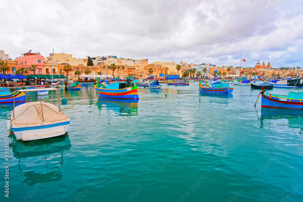 Luzzu boats on Marsaxlokk harbor in bay Mediterranean sea Malta