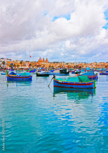 Luzzu boats in Marsaxlokk harbor in bay Mediterranean sea Malta