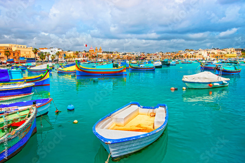 Luzzu boats in Marsaxlokk harbor of bay Mediterranean sea Malta