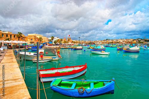 Luzzu boats at Marsaxlokk Port in Mediterranean sea Malta