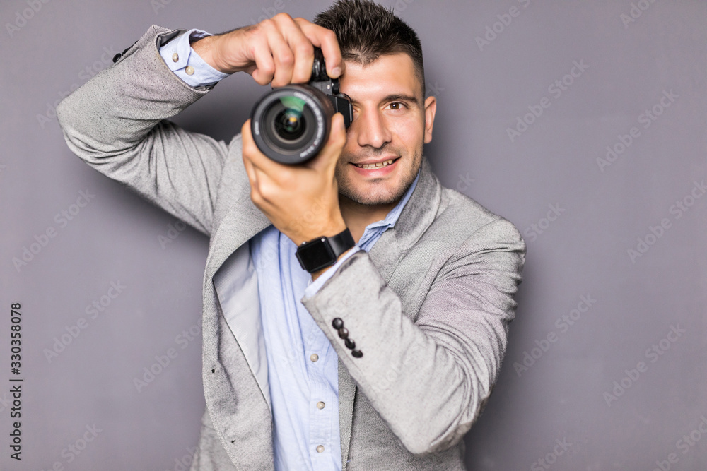 Young photographer man standing with camera in modern office Young photographer man standing with camera in modern office