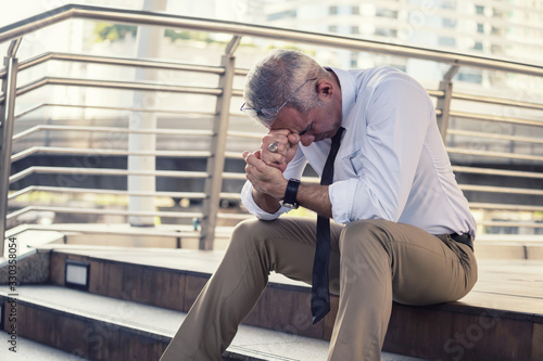 Anxious old businessman in city