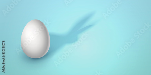 Easter creative vector illustration in modern minimalist style. Egg on a blue background with a shadow in the form of an Easter rabbit. Trendy design for sale, advertisement, web. place for text