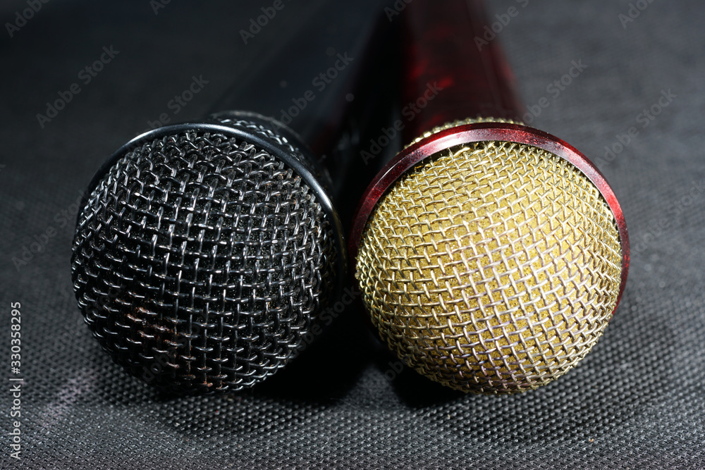 Obraz premium Microphones with wire mesh network photographed in the studio with flash light