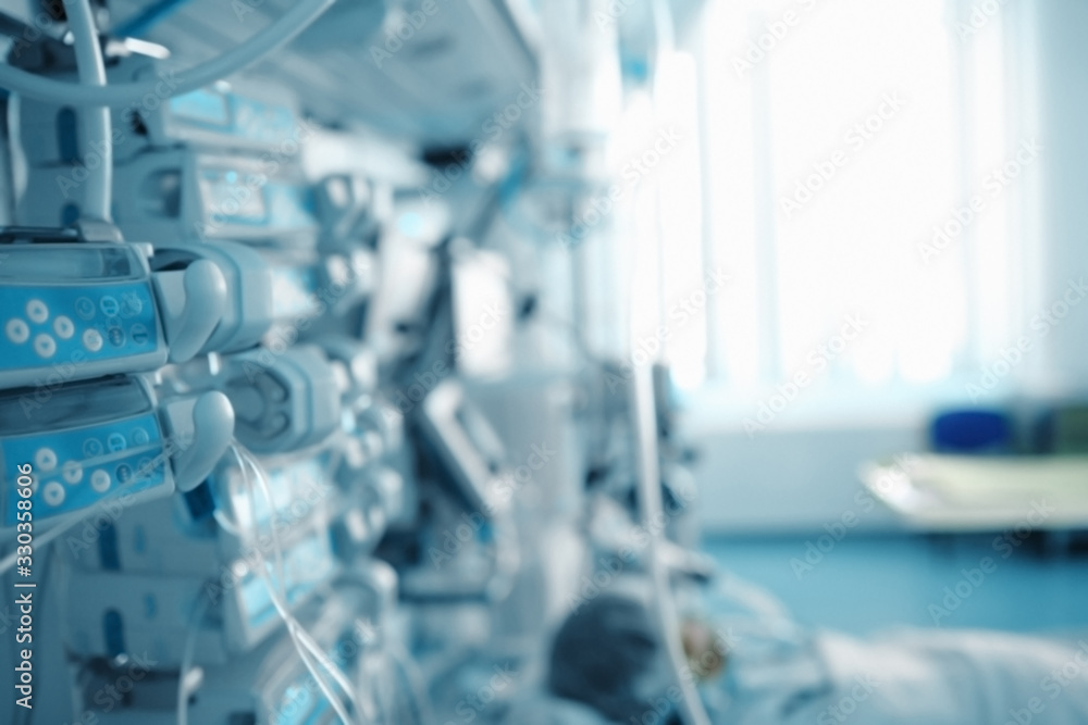 Patient after surgery in the advanced equipped ICU, unfocused background Patient after surgery in the advanced equipped ICU, unfocused background