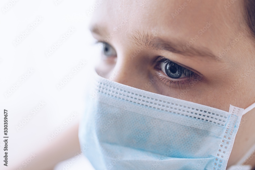 Sad boy in medical protective mask. Child during coronavirus epidemic Sad boy in medical protective mask. Child during coronavirus epidemic