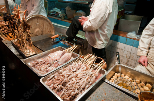 Small restaurant serving food on skewers for exemple fried octopuses  at Wangfujing Snack Street in Dongcheng District, Beijing, China